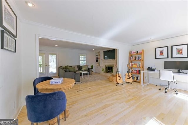 3811 Valley Green Dr, Marietta, GA 30068 - living room with crown molding, wood finished floors, a fireplace with raised hearth, a desk, and recessed lighting