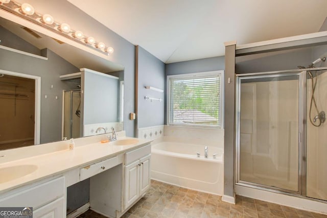 full bathroom with a shower stall, a garden tub, a sink, and double vanity