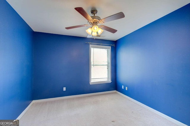 spare room featuring baseboards, carpet floors, and ceiling fan