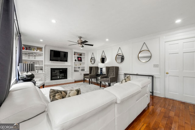 292 Old Rosser Rd, Stone Mountain, GA 30087 - living area with ornamental molding, dark wood-style flooring, a brick fireplace, recessed lighting, and a ceiling fan