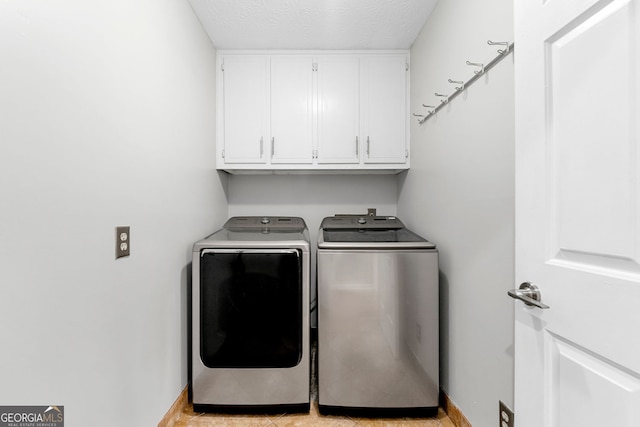 292 Old Rosser Rd, Stone Mountain, GA 30087 - laundry room with cabinet space, a textured ceiling, baseboards, and washer and dryer
