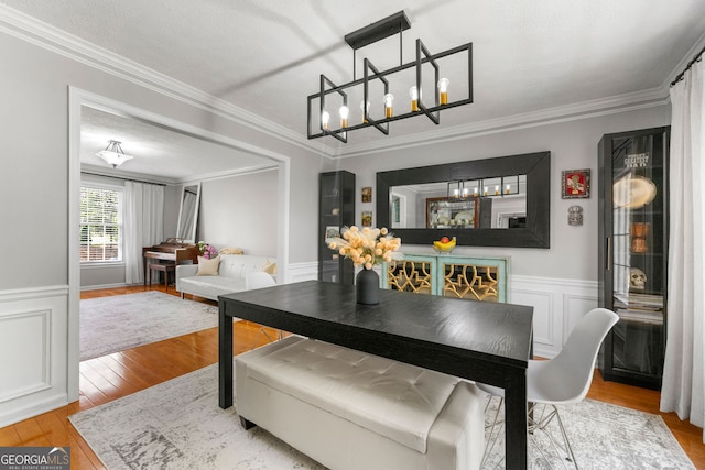292 Old Rosser Rd, Stone Mountain, GA 30087 - dining room featuring ornamental molding, wood finished floors, a chandelier, and a wainscoted wall