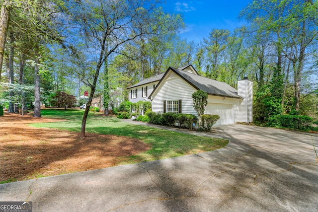 292 Old Rosser Rd, Stone Mountain, GA 30087 - view of side of property with a garage, a chimney, a yard, and driveway