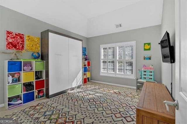 playroom with baseboards, vaulted ceiling, and visible vents