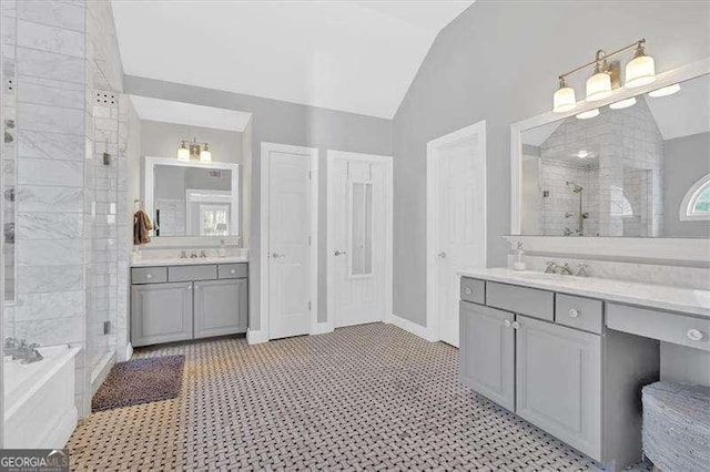 bathroom featuring a shower stall, a sink, and lofted ceiling