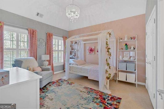 carpeted bedroom with a chandelier, baseboards, and visible vents