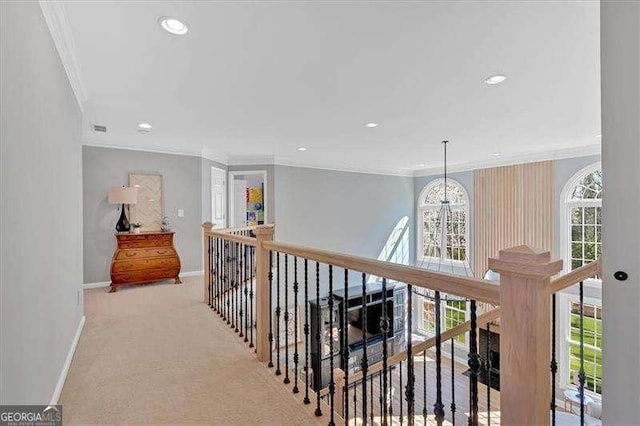 hallway featuring baseboards, an upstairs landing, crown molding, carpet floors, and recessed lighting