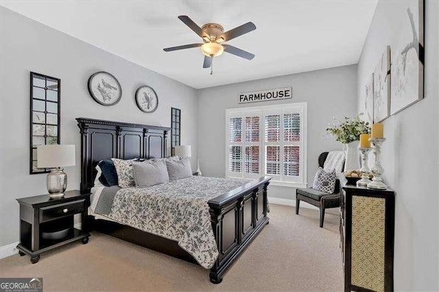 bedroom featuring light carpet, baseboards, and a ceiling fan