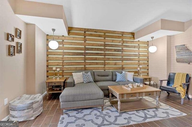 living area featuring baseboards and wood tiled floor