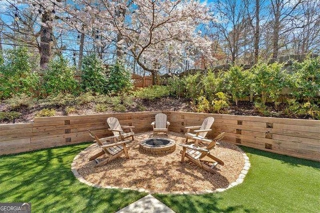 view of yard featuring a fire pit and fence