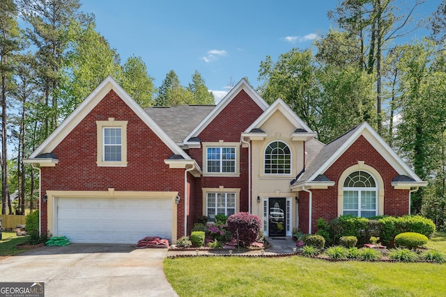 view of front facade with brick siding, an attached garage, driveway, and a front yard