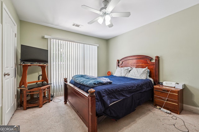 bedroom featuring light carpet, baseboards, visible vents, and ceiling fan