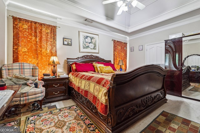 carpeted bedroom with a raised ceiling, ceiling fan, visible vents, and ornamental molding
