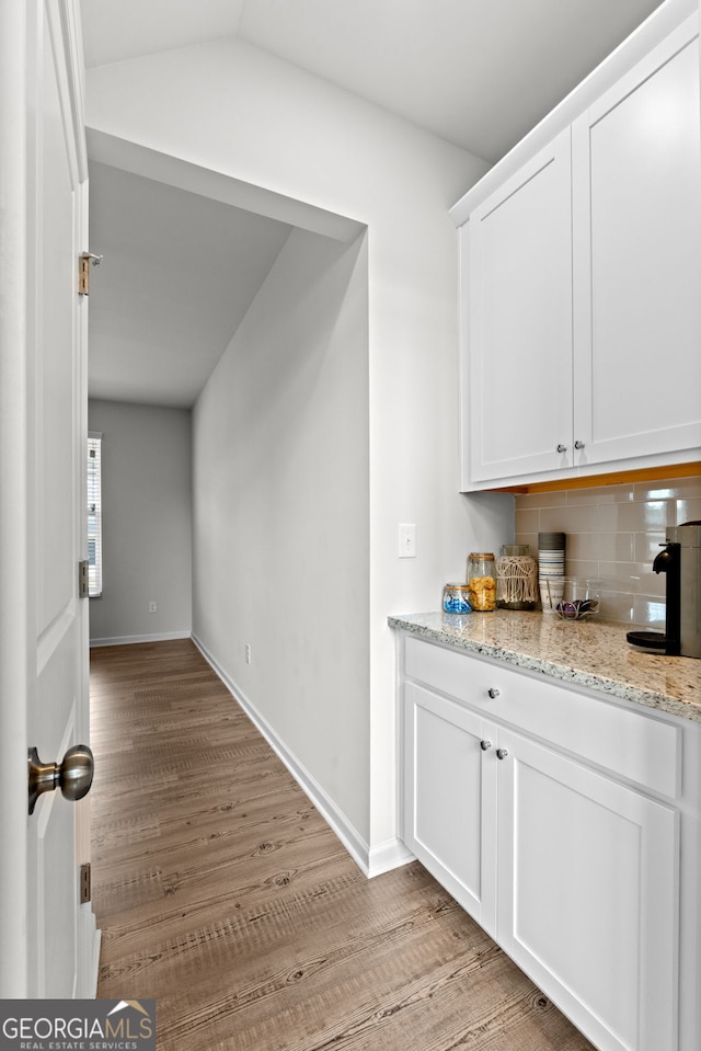 133 Bastian Rd, Mcdonough, GA 30252 - bar with tasteful backsplash and light wood-style floors