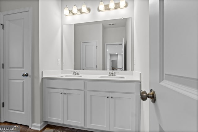 133 Bastian Rd, Mcdonough, GA 30252 - bathroom with double vanity and wood finished floors