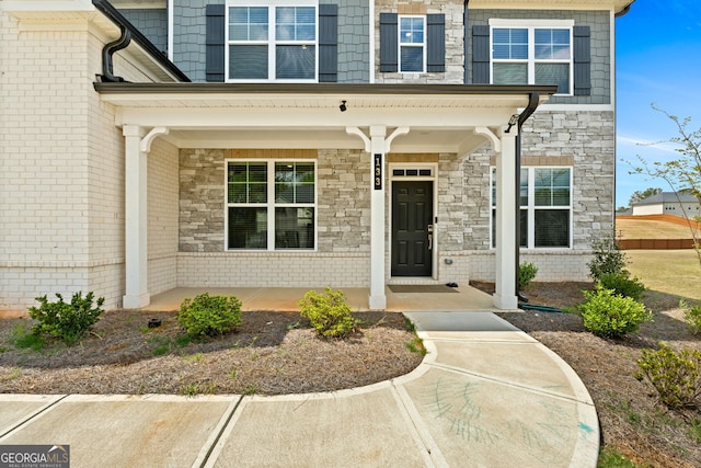 133 Bastian Rd, Mcdonough, GA 30252 - doorway to property with a porch and stone siding