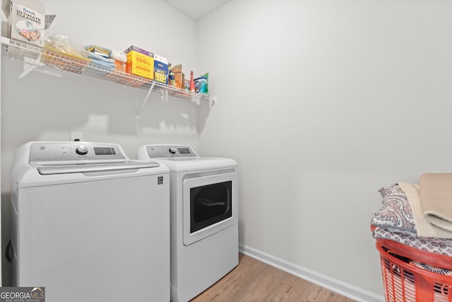 133 Bastian Rd, Mcdonough, GA 30252 - washroom featuring washing machine and clothes dryer and light wood-type flooring