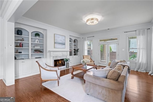715 Saybeck Way, Milton, GA 30004 - living room featuring dark wood-style floors, ornamental molding, a fireplace, built in shelves, and baseboards
