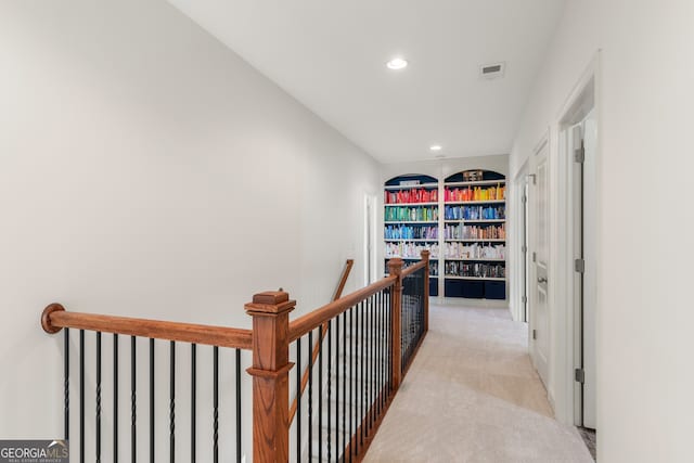 hall featuring recessed lighting, visible vents, light carpet, and an upstairs landing