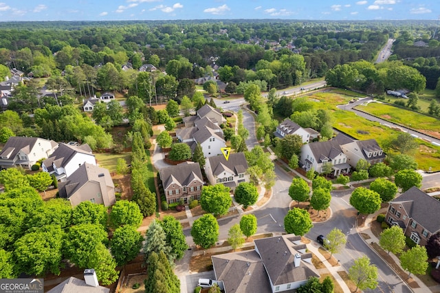 bird's eye view featuring a wooded view and a residential view