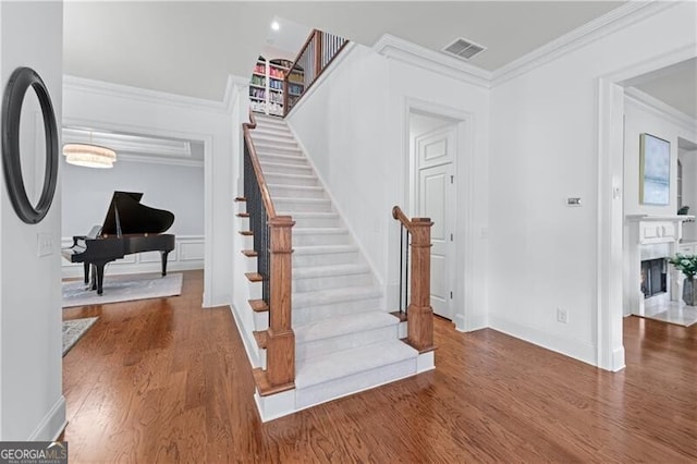 715 Saybeck Way, Milton, GA 30004 - staircase with wood finished floors, crown molding, a fireplace, and baseboards