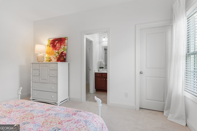 bedroom with baseboards and light carpet