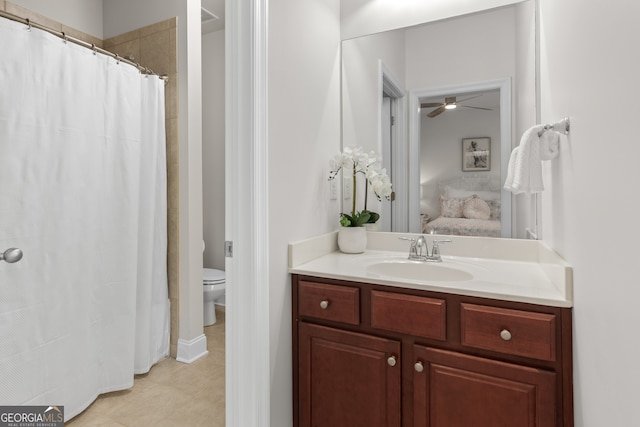 full bath with toilet, ceiling fan, ensuite bathroom, and vanity
