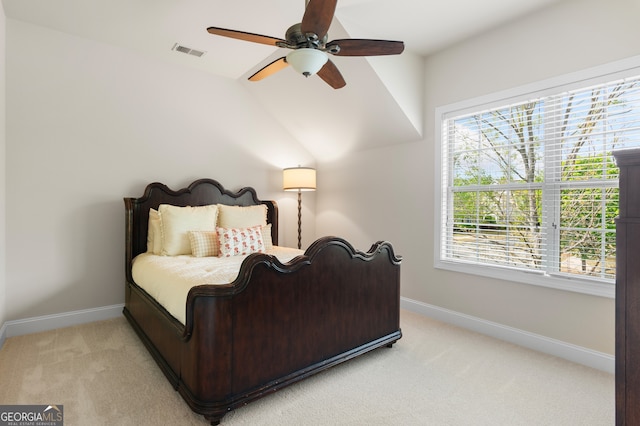 bedroom with visible vents, light carpet, and multiple windows