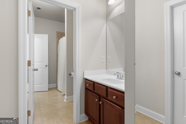 bathroom with vanity, baseboards, tile patterned flooring, and visible vents
