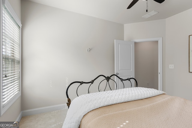 bedroom with carpet flooring, a ceiling fan, baseboards, and visible vents