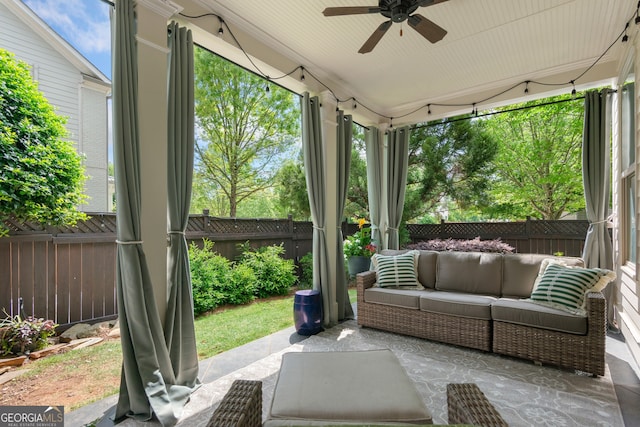sunroom / solarium featuring a ceiling fan and an outdoor hangout area