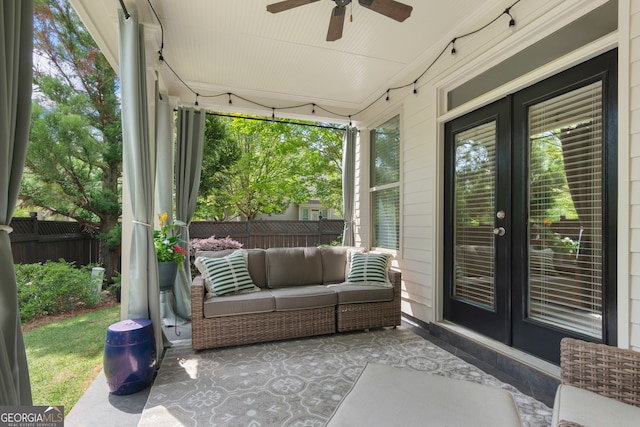 sunroom / solarium with ceiling fan and french doors