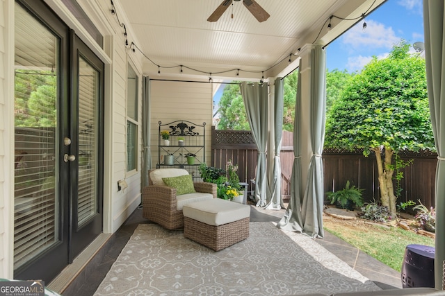 view of patio / terrace with ceiling fan and fence