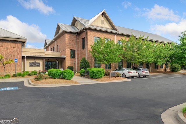 view of building exterior featuring uncovered parking