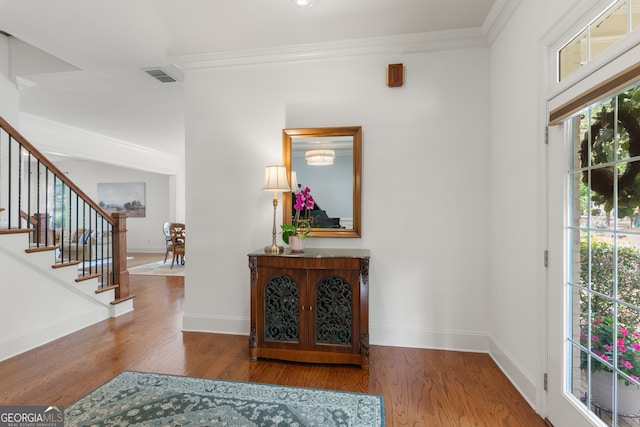entryway featuring baseboards, visible vents, and wood finished floors