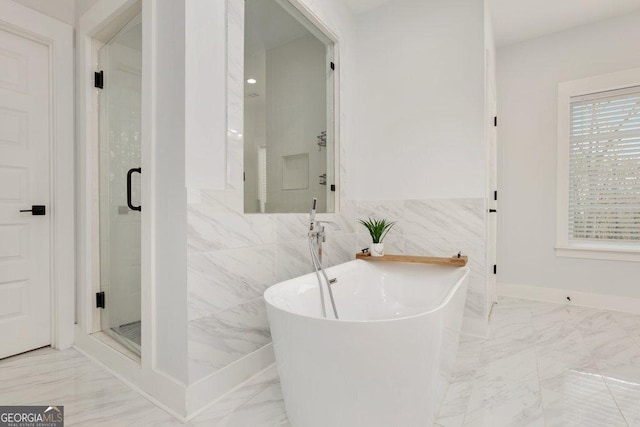 4980 Wildeoak Trl, Douglasville, GA 30135 - full bath featuring marble finish floor, a freestanding tub, a stall shower, and tile walls