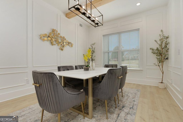 4980 Wildeoak Trl, Douglasville, GA 30135 - dining room with visible vents, light wood-style flooring, a decorative wall, and a chandelier