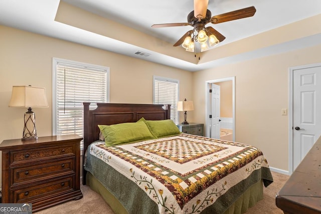 155 Duncans Mill Dr, Locust Grove, GA 30248 - bedroom with light colored carpet, baseboards, a raised ceiling, visible vents, and ensuite bathroom