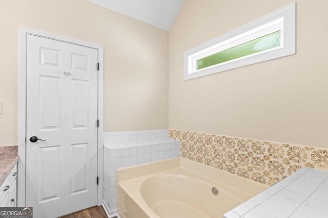 155 Duncans Mill Dr, Locust Grove, GA 30248 - full bath with a bath, vaulted ceiling, and vanity