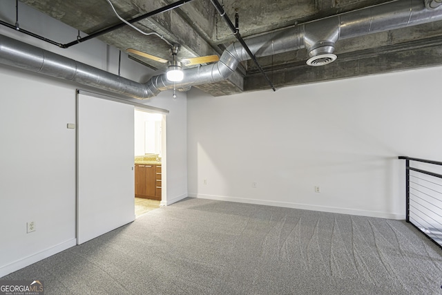 below grade area featuring baseboards, visible vents, and carpet