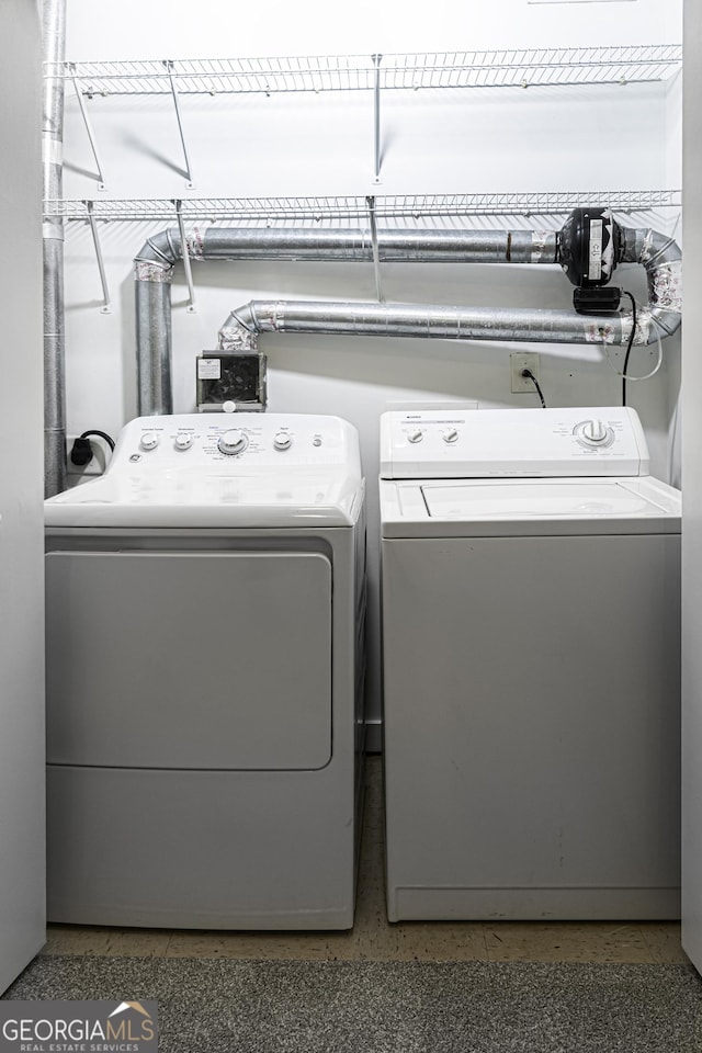 laundry room with separate washer and dryer and laundry area