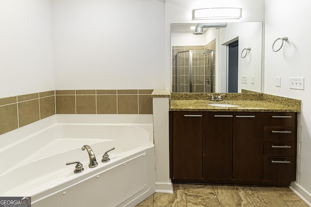 full bathroom featuring vanity, a garden tub, and a shower stall