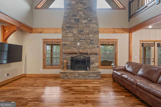 142 Holland Dam Dr, Maysville, GA 30558 - living room featuring a stone fireplace, a healthy amount of sunlight, and wood finished floors