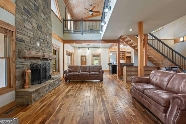 142 Holland Dam Dr, Maysville, GA 30558 - living area with ceiling fan, a towering ceiling, visible vents, a fireplace, and wood finished floors