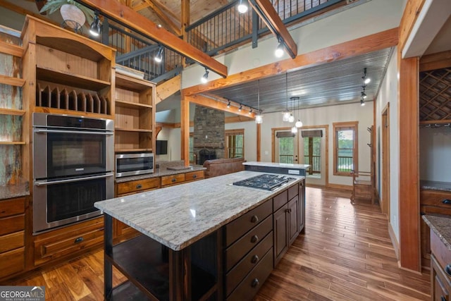 142 Holland Dam Dr, Maysville, GA 30558 - kitchen featuring dark wood-style floors, a kitchen island, appliances with stainless steel finishes, and open shelves