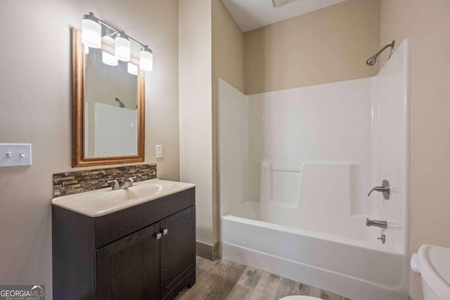 142 Holland Dam Dr, Maysville, GA 30558 - full bath featuring wood finished floors, toilet, vanity, and shower / bath combination