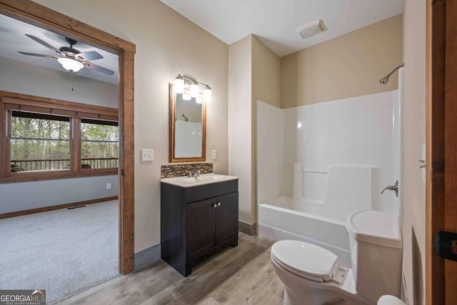 142 Holland Dam Dr, Maysville, GA 30558 - full bath featuring toilet, vanity, a ceiling fan, shower / bathtub combination, and wood finished floors