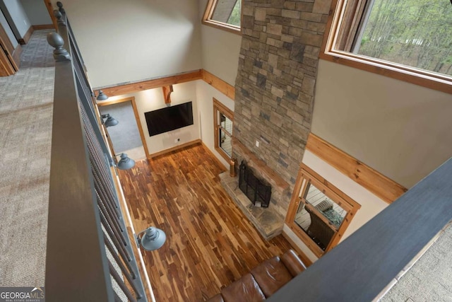 142 Holland Dam Dr, Maysville, GA 30558 - living room featuring a towering ceiling, baseboards, and wood finished floors