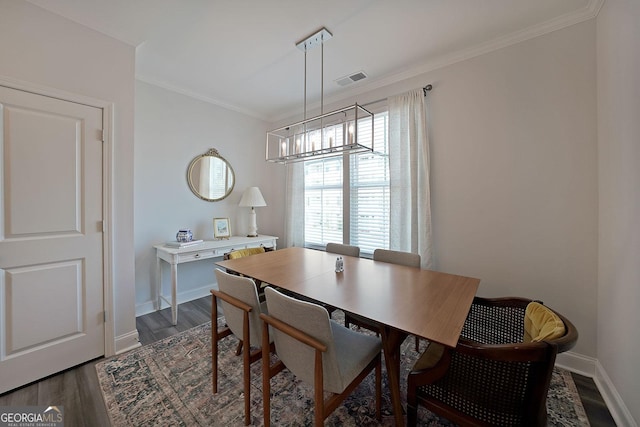 3323 Owl Creek Pkwy, Acworth, GA 30102 - dining room featuring dark wood-type flooring, baseboards, ornamental molding, and a chandelier