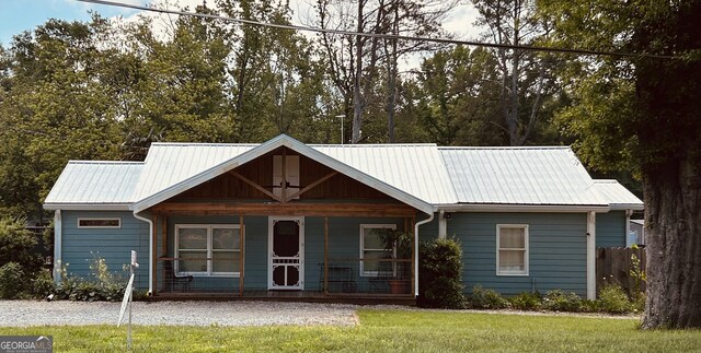 6121 N Main St SE, Acworth, GA 30101 - view of front of home with covered porch, a front lawn, and metal roof